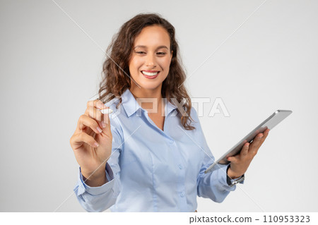 Smiling caucasian young businesswoman use tablet, write pencil on virtual screen 110953323