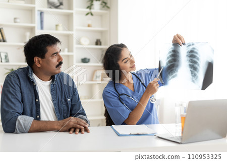 Young Doctor Lady Demonstrating Chest X-Ray To Mature Male Patient In Clinic Young Doctor Lady Demonstrating Chest X-Ray To Mature Male Patient In Clinic 110953325
