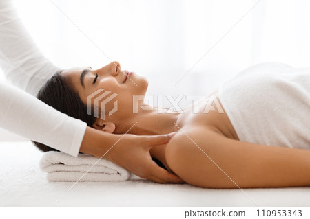 Joyful woman getting relaxing body shoulders massage at wellness center 110953343