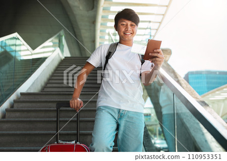 Happy young asian man going vacation, showing passport 110953351