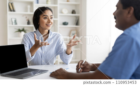 Young Indian Female Patient Talking To Male Doctor During Meeting In Clinic 110953453