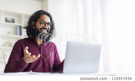 Online Coaching. Indian Male Tutor Making Video Call With Laptop And Headset Online Coaching. Indian Male Tutor Making Video Call With Laptop And Headset 110953456