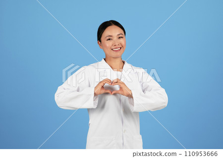 Smiling Asian Female Doctor In Uniform Making Heart Sign With Hands Smiling Asian Female Doctor In Uniform Making Heart Sign With Hands 110953666