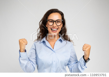 Glad excited pretty young european woman in glasses enjoy win, surprise, celebrate success in work 110953701