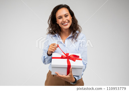 Happy millennial european lady in formal wear open box with gift, enjoy birthday 110953779