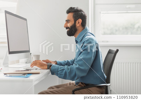 Focused indian businessman working on computer in office Focused indian businessman working on computer in office 110953820