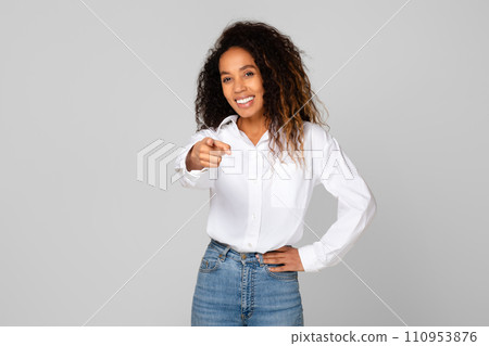 black lady pointing finger at camera against gray studio background 110953876