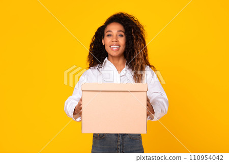 Happy African American Woman Holding Cardboard Parcel Box, Yellow Background 110954042