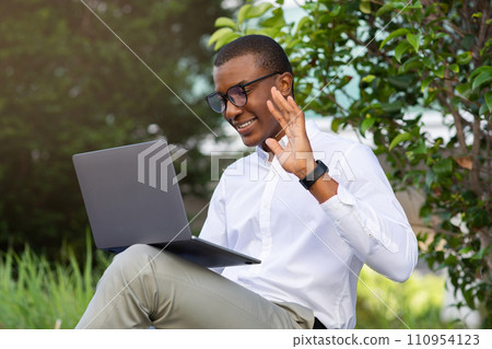 Teleconference Concept. Handsome Black Businessman Making Video Call With Laptop Outdoors 110954123