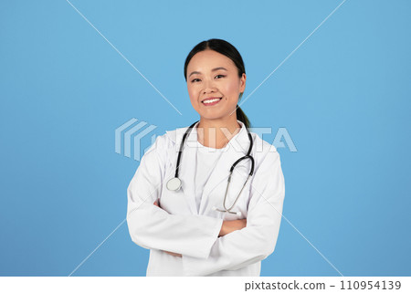 Portrait Of Smiling Asian Doctor Woman In Uniform Standing With Arms Crossed 110954139