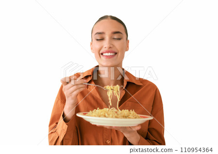 Joyful woman enjoying a plate of spaghetti 110954364