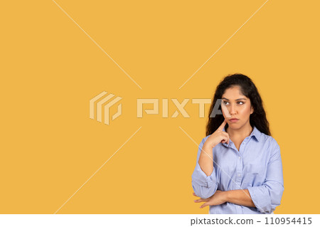 Pensive latin young brunette woman in casual think, look up at free space, create idea Pensive latin young brunette woman in casual think, look up at free space, create idea 110954415