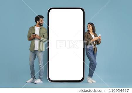 Stylish young indian man and woman using phones Stylish young indian man and woman using phones 110954457