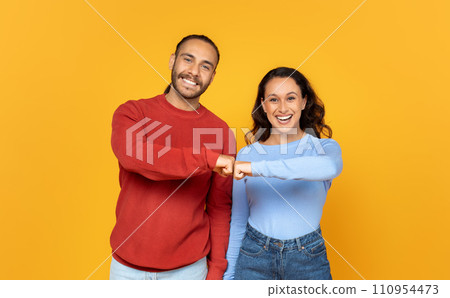 Glad millennial european couple in casual bumping fists 110954473