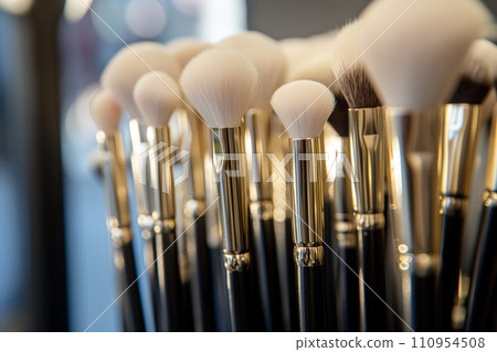 A Make-up brushes laid out in a row, the fine bristles and sleek handles demonstrating precision and quality, set against a minimalist backdrop, focus on the details and craftsmanship 110954508