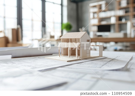 A well-organized scene showing architectural project drawings, with a miniature house model placed beside them, representing the translation of plans into a tangible structure, A well-organized scene showing architectural project drawings, with a miniature house model placed beside them, representing the translation of plans into a tangible structure, 110954509