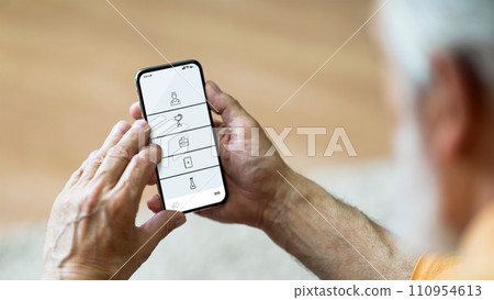 Senior man at home using medical app on smartphone Senior man at home using medical app on smartphone 110954613