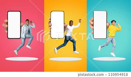 Cheerful excited young black and asian people show big smartphone with empty screen 110954918