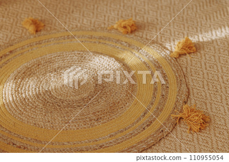 Woven mat with yellow tassels. Woven mat with yellow tassels. 110955054