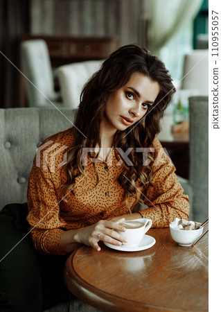 Caucasian woman enjoying coffee in cafe. 110955057