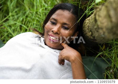 close-up of woman lying in the grass close-up of woman lying in the grass 110955079