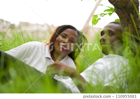 happy couple lying in the grass happy couple lying in the grass 110955081