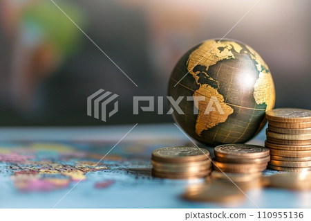 An globe next to a stack of coins, symbolizing the global economy and the impact of financial decisions on the world 110955136