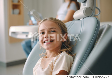 A young girl with a big smile sitting in a dental chair. 110955224