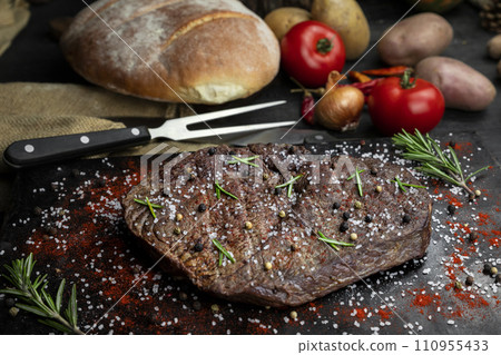 Beef steak seasoned with salt, pepper and fresh hearbs searved in the kitchen 110955433