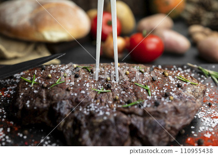 Beef steak seasoned with salt, pepper and fresh hearbs searved in the kitchen 110955438