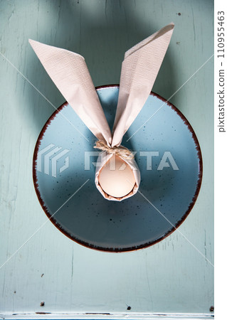 egg wrapped in easter bunny shaped napkin egg wrapped in easter bunny shaped napkin 110955463