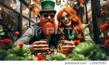 AI-generated content. A modern man with a red beard and a woman with red hair wearing green St. Patrick's Day hats sit at a street cafe table and drink beer. Cheerful couple celebrating Irish national 110955567