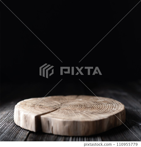 Wooden plate carved from tree trunk on old grunge wooden table Wooden plate carved from tree trunk on old grunge wooden table 110955779