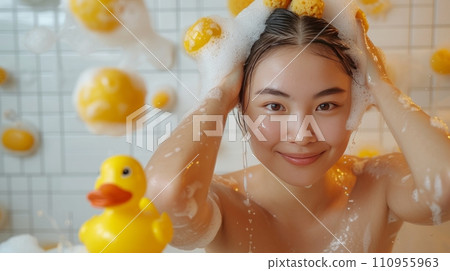 Young beautiful Asian woman washes her hair in the shower 110955963