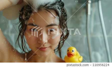 Young beautiful Asian woman washes her hair in the shower Young beautiful Asian woman washes her hair in the shower 110956224