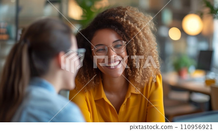 A Joyful CEO and Her Young Colleague Engage in Office Discussion A Joyful CEO and Her Young Colleague Engage in Office Discussion 110956921