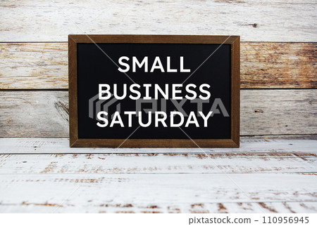 Small Business Saturday typography text on wooden blackboard 110956945