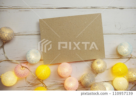 Empty Paper Caft with LED cotton balls on wooden background Empty Paper Caft with LED cotton balls on wooden background 110957139