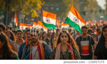 A group of people walk down the street with Indian flags 110957175