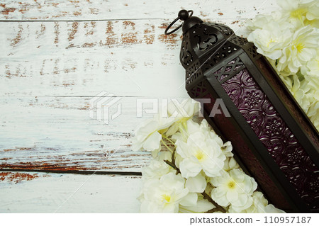 Black Moroccan Arabic lantern with flower on white table background 110957187