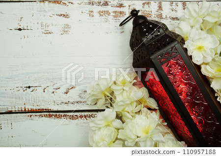 Black Moroccan Arabic lantern with flower on white table background 110957188