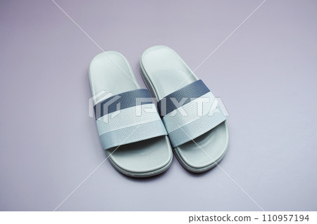 Gray slide sandal summer slippers on purple background 110957194
