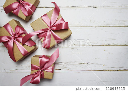 Gift boxes with pink ribbon on wooden background 110957315