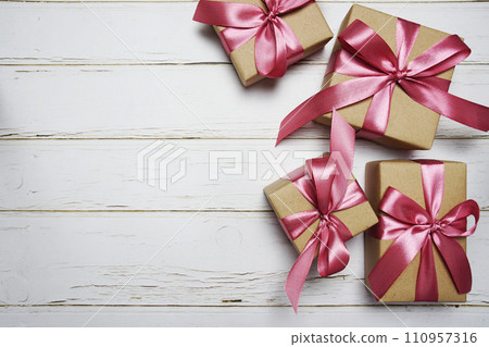 Gift boxes with pink ribbon on wooden background 110957316