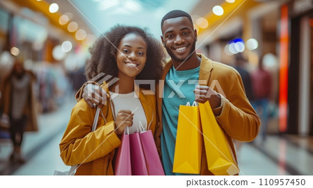 A woman and her boyfriend are all smiles as they enjoy a day of shopping together at the mall 110957450