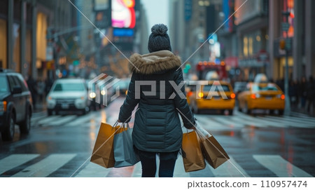 A woman carries two heavy shopping bags through the streets of city A woman carries two heavy shopping bags through the streets of city 110957474