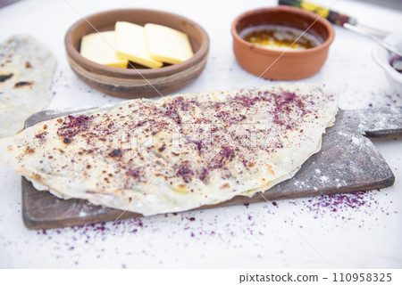 Front view of stylish. wooden board with flour and pita, shawurma lying on white table outdoor. Concept of fast food. 110958325