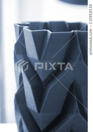 Art object vase printed on a 3D printer. Models created by a 3D printer from blue molten plastic. Concept 3d printing. Additive progressive technologies. New modern technology for creating objects 110958538