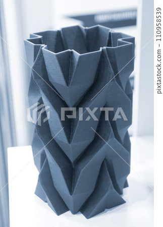 Art object vase printed on a 3D printer. Models created by a 3D printer from blue molten plastic. Concept 3d printing. Additive progressive technologies. New modern technology for creating objects 110958539