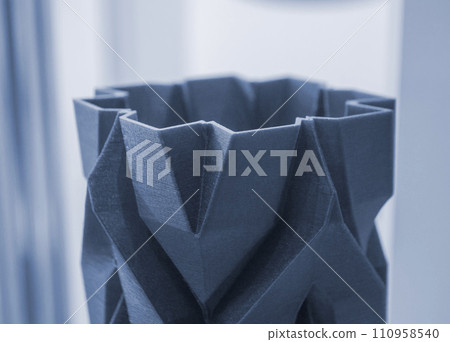 Art object vase printed on a 3D printer. Models created by a 3D printer from blue molten plastic. Concept 3d printing. Additive progressive technologies. New modern technology for creating objects 110958540